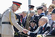 King Charles III greeting veterans at the British Normandy Memorial in Ver-sur-Mer, France to mark the 80th anniversary of the D-Day landings.
