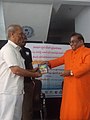 Receiving Book presentation from Prabhodaananda yogeeswarlu