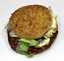 Ground beef patty between two disks made of compressed rice