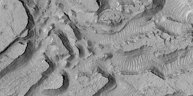 Enlarged view of a group of mesas, as seen by HiRISE under HiWish program. One surface is forming square shapes.