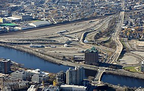 Beacon Park rail yard, upper left and Interstate 90 Allston interchange, center, facing south-west. Under the proposed plan, I-90 would be moved closer to the MBTA mainline at the southern edge of the yard. West Station would be constructed near the large white building at top left.