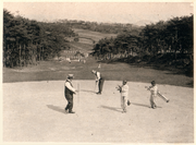 Golfers playing around fenced-off tombs in what is now Hyochang Park