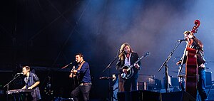 Mumford & Sons performing in 2015. From left to right: Ben Lovett, Marcus Mumford, Winston Marshall, and Ted Dwane.