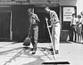 Two boys sweeping out front of the opening of the first Anacostia Museum