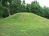 A large grass-covered mound