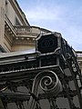 The royal cypher of King Carol II of Romania (two opposed Cs) decorates the porch roofs at the entrances in the Royal Palace of Bucharest.