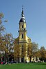 Almost straight-on view of the muted yellow, narrow, tall tower entrance of Saint Paulin Church