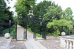Clare College gateway on west side of Clare Bridge with flanking railings and gates to College Garden