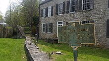 a picture of the marker with the Depuy house and a lock from the D&H Canal in the background