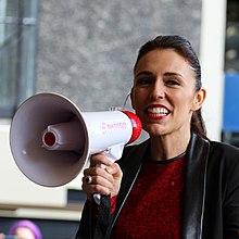 Ardern speaking into a megaphone