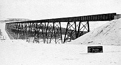 view of long railroad viaduct in a snowy landscape