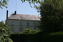 vue de l'ancien moulin avec une haie au premier plan