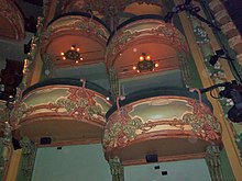 View of the box seats in the auditorium, which contain various decorations