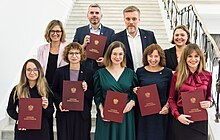 All nine "Together" politicians posing in Sejm holding the National Electoral Commission certification