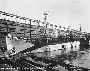 USS Lenape (ID-2700) on 20 August 1918. Note the coal barges and Lenape's open coaling doors.