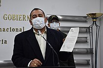 Wilson Santamaría holds up a document during a press conference.