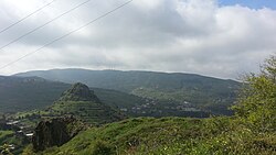 The ruined hilltop fortress of Qulay'a and the modern village below, 2015