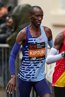 Black man in a blue top running
