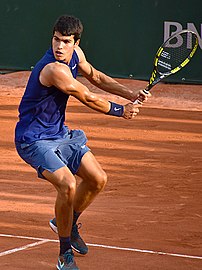Carlos Alcaraz, the 2024 men's singles champion. At 21, he became the youngest male player to win a major title on three different surfaces.