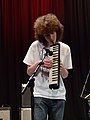 Melodica being played vertically, with one hand and without air tube