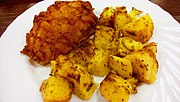 A Pozharsky cutlet with cubed potatoes on a plate