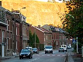 Image of a road with cars and some houses