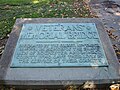 Plaque located along Route 104 on the west side of the bridge