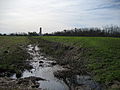 The remains of the canal today, with the finished Chalmette Monument in the background.