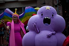 The image depicts two individuals dressed up as characters from the show