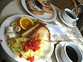 A brunch of an omelette, toast, French toast, fruit and coffee