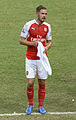 A footballer wearing a red and white kit