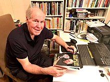 2019 photo of Philip Capelle autographing his instructional book on pool for a fan.