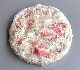 A wrapped, mass-produced frozen pizza to be baked at home