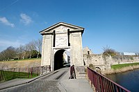 The Gate of Cassel, on a triangular pediment, incorporating the radiating sun of Louis XIV.