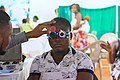 a patient wearing trial frame while doing refraction