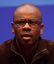 A dark-skinned man wearing a black fleece