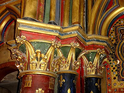 Lower chapel, column capital on reverse of west front. Castles and fleur-de-lis symbols seen here on the columns, are found throughout the chapel, relating to the two royal families from which Louis IX descended (the Capet fleur-de-lis through his father, Louis VIII of France, and the Castile castle through his mother, Blanche of Castile).