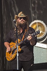 A picture of country music singer Chris Stapleton playing an electric guitar