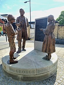 The artwork depicts Boole at a blackboard teaching a boy and girl that the symbols of logic are subject to a special law.