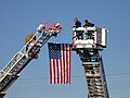 Tower 602 & Truck 690 perform a flag arch