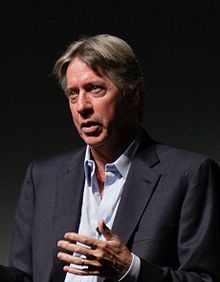 A standing Alan Silvestri, gesturing with one hand