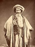 Arab man smoking pipe, late 1800s.