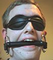 A man, blindfolded and gagged