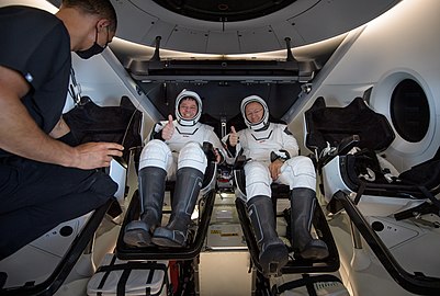 Behnken and Hurley inside Endeavour are greeted by SpaceX medical director Anil Menon on board GO Navigator.