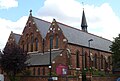 St Thomas's Church, Islington, London, 1888–89 by Ewan Christian, view of west front and south aisle showing Early English style lancets and narthex below the west windows[156]