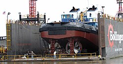 Towboat Dolphin I in Bollinger Shipyards floating Drydock #2 on the Mississippi River in Algiers, New Orleans, Louisiana