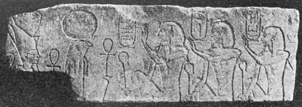 Relief showing three kings looking right, with hieroglyphs around their heads