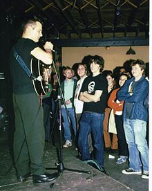 Johnson in front of a microphone with a guitar