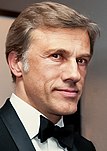 Christoph Waltz wearing a suit and a bowtie in 2012.