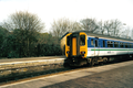 A First North Western Class 156 at Romiley Junction station, near Manchester in the year 2001. It is in it's former 'Network North Western' Regional Railways livery.